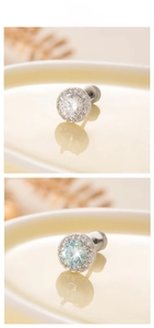 Macro shot of round cubic zirconia earrings in silver finish with halo diamond setting