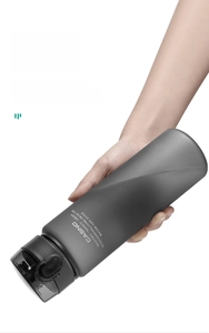 Leakproof test of frosted gray sports bottle showing secure silicone seal in cap