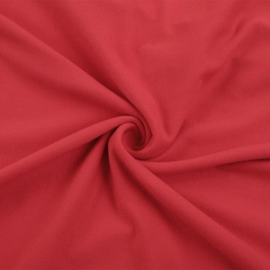 Close-up of premium red fabric texture with soft drapes and elegant sequin details