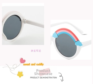 Detail of white round children sunglasses with rainbow bridge and blue cloud decor