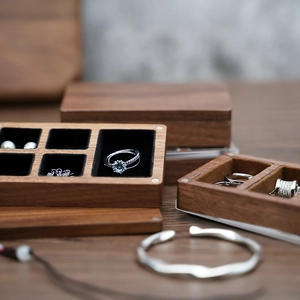 Close-up of black walnut wood jewelry box with soft velvet lining for ring storage