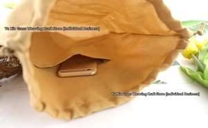 Detail of the woven bag interior featuring a drawstring liner and mobile phone pocket