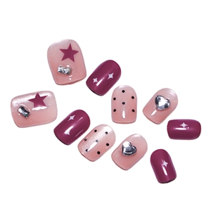 Pink cat eye press-on nails with heart rhinestones and black polka dots star design