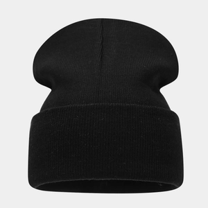 Detailed close-up of the black ribbed knit texture on the winter beanie hat
