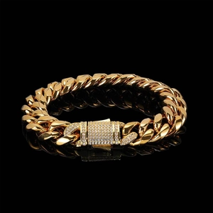 Macro detail of 18k gold plated Cuban link bracelet with diamond-encrusted spring clasp