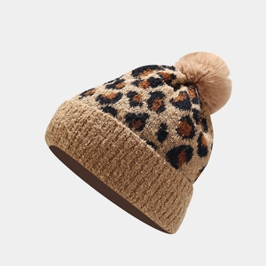Women's leopard print knit beanie with fluffy faux fur pom pom and ribbed cuff