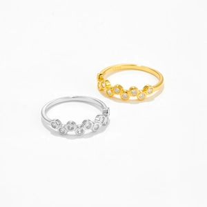 Close-up of S925 sterling silver wave rings with sparkling zircon in gold and silver