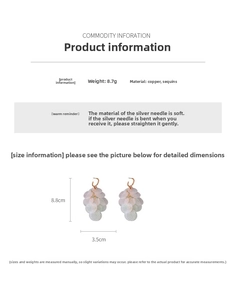 Detailed view of silver needle tassel C-shape earrings showing size and iridescent sequins
