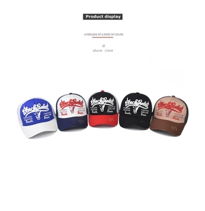 Close-up of vintage washed baseball caps with bull embroidery and distressed brim details