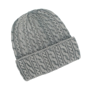 Detailed cable knit texture and wide folded cuff of a grey winter beanie hat