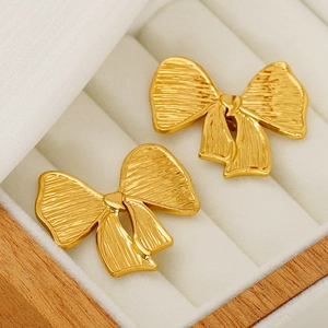 Vintage golden bow-knot stainless steel stud earrings in a wooden jewelry gift box