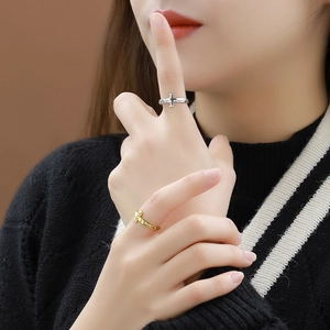 S925 sterling silver cross ring with irregular pleated texture on a model's hand