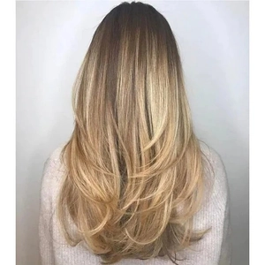 Long blonde wavy layered synthetic wig for women with a natural gradient back view