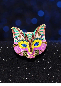 Detailed macro view of vintage cat mask brooch featuring colorful enamel and rhinestones