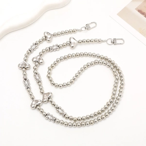 Detail of silver beaded phone strap with metal hearts and cute bear charms