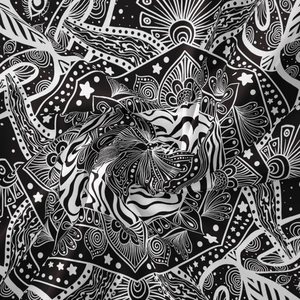 Macro shot of monochromatic mandala tapestry fabric showing texture and moon phase patterns