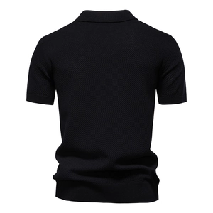 Rear view of black waffle knit polo shirt showing premium texture and ribbed hem