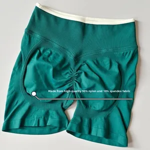 Detail of green high waist yoga shorts with scrunch butt and 90% nylon 10% spandex fabric