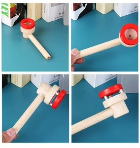 Detail of wooden floating ball training pipe with smooth natural finish and red rim