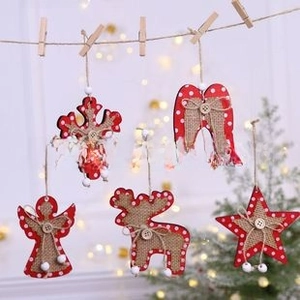 Detail of red wooden Christmas ornaments with white dots and burlap heart accents on rope