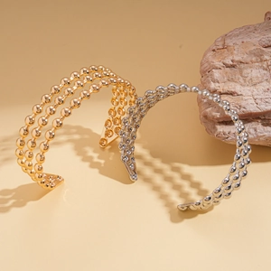 Bracciale rigido aperto a tre strati con sfere geometriche in oro e argento lucido