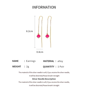 Detail view of pink square resin earrings with gold chain links and 8.2cm length