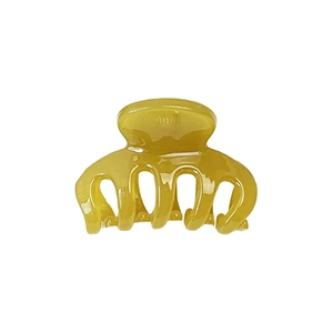 Translucent ginger yellow hair claw clip with minimalist resin design on white background
