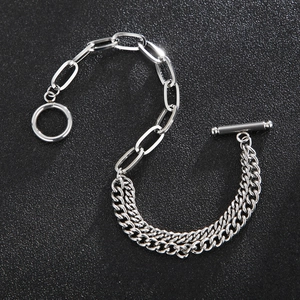 Detail of silver OT toggle clasp and mixed Cuban chain links on black background