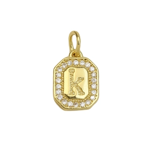 Macro view of gold 18k octagonal pendant featuring crystal inlay and letter K design