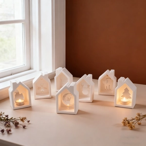 Seven-piece set of white matte ceramic house candle holders with hollow festive patterns