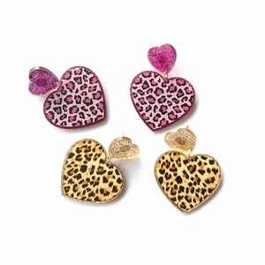 Pink and brown leopard print heart earrings with glitter details on white background