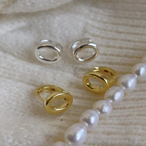 Minimalist S925 sterling silver hoop earrings in gold and silver set on knit background