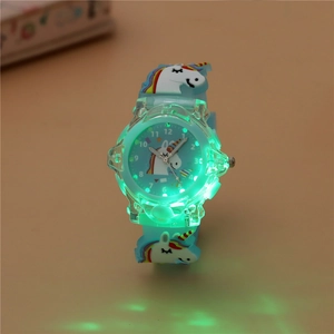 Close-up of kids glowing LED watch featuring blue silicone strap and unicorn motif