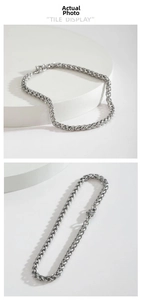 Macro view of a chunky silver stainless steel wheat chain bracelet with lobster clasp