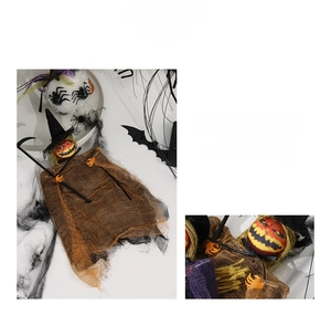 Detail of Halloween pumpkin ghost hanging ornament with witch hat and wizard staff prop