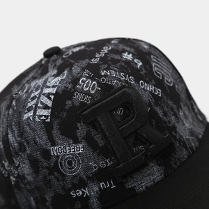 Detailed close-up of 3D R-letter embroidery and printed text on a black hip-hop cap