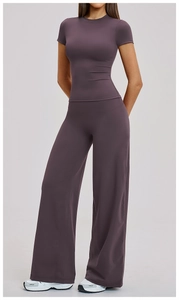 Detail of high-waisted wide-leg yoga pants and slim-fit top in deep purple-gray fabric