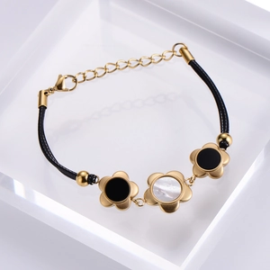 Detail of 18k gold plated plum blossom bracelet with black and white shell inlays