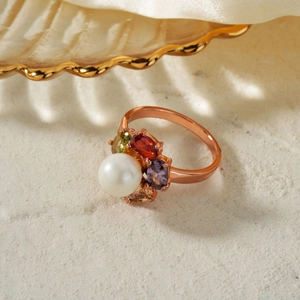 Exquisite rose gold flower ring with pearl and colorful gemstones on a beige background