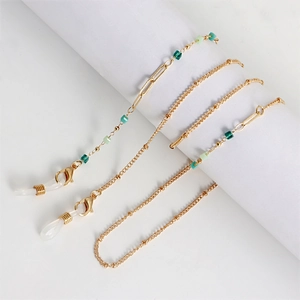 Detail of gold metal eyewear chain with green and blue square beads and lobster clasps