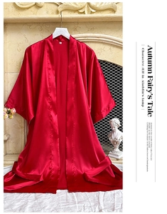Detailed view of dark red satin silk bathrobe texture with shoulder seams and size S label