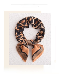 Detail of faux silk square scarf featuring classic leopard print and black wavy borders