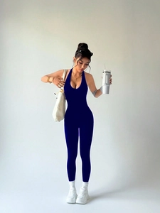 Detail of navy blue halter neck yoga jumpsuit featuring backless design and slim fit cut