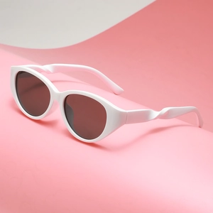 White cat-eye sunglasses with spiral temple design on a soft pink background