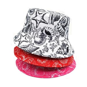 Detailed pattern of ocean-themed prints with starfish and coral on colorful bucket hats