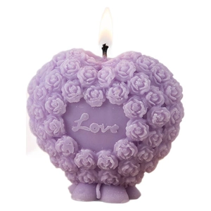 Lit purple heart-shaped candle with rose relief and Love engraving on white background