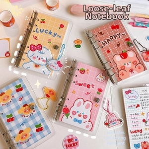 Detailed view of transparent PVC loose-leaf notebook binders with cute cartoon designs