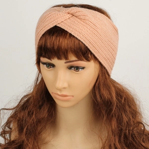 Detail shot of pink knitted headband featuring a warm fleece lining and twist knot design
