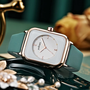 Detailed macro view of the rose gold square watch case with minimalist dial design