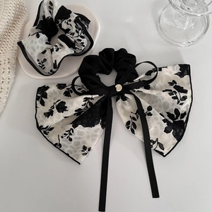 Elegant French floral scrunchie and bow ribbon hair tie in classic black and white